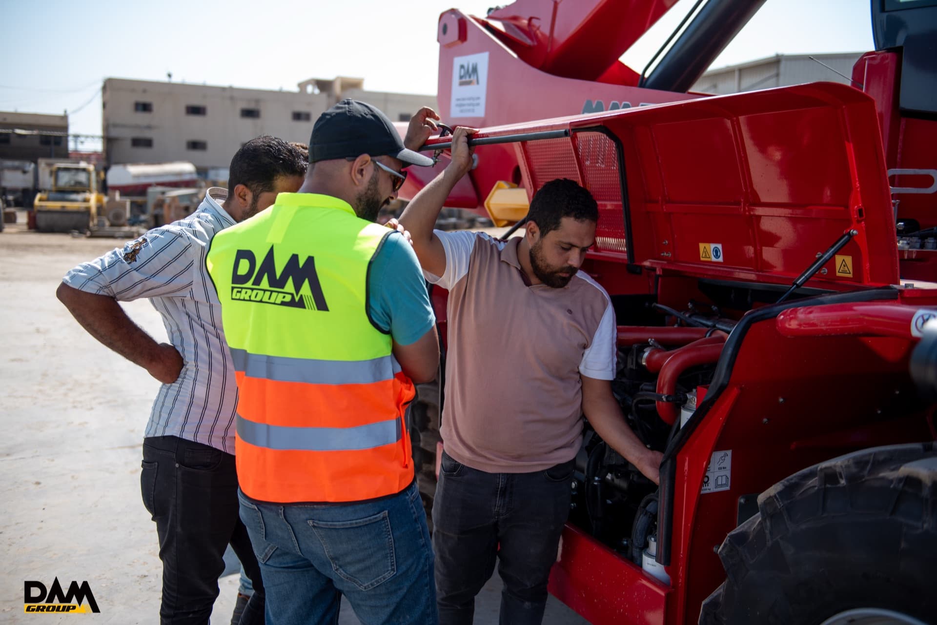 DAM technicians inspecting the engine of a Magni telehandler